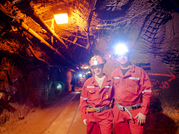 Two mine workers in an underground excavation